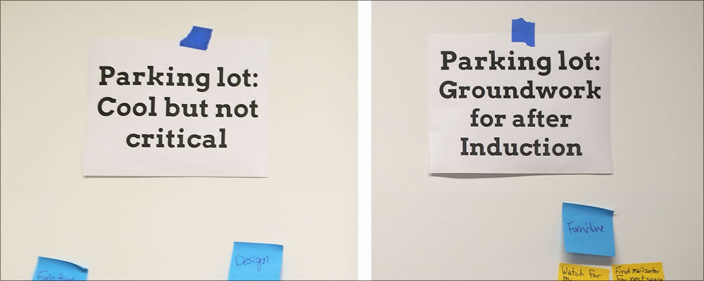 Photo of a paper parking lot sign where ideas on sticky notes can be posted for later consideration