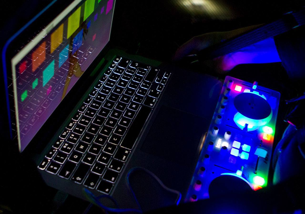 A close-up photo of the laptop and MIDI controller.