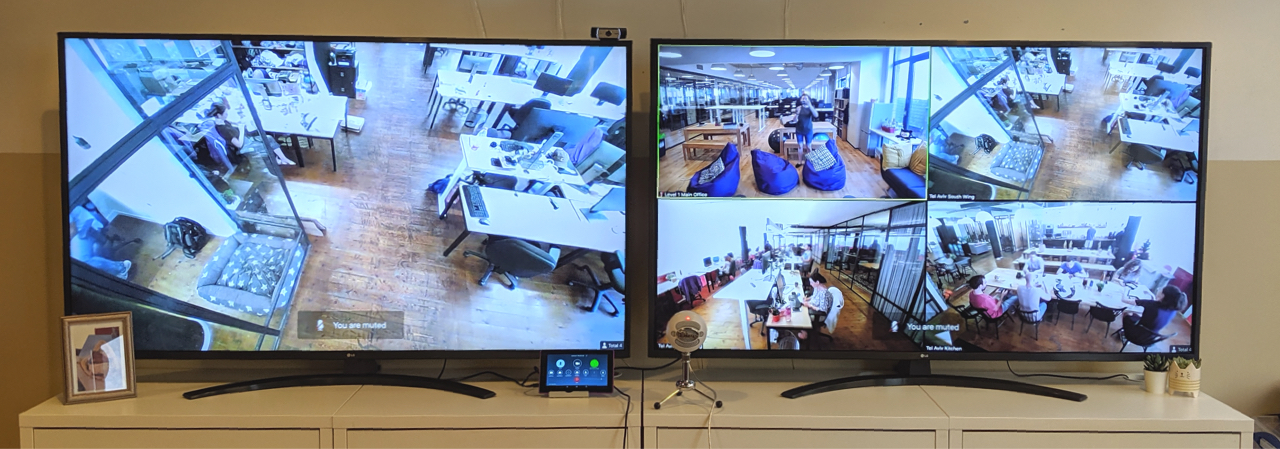 a photo of two TV screens side by side displaying video streams from different offices.